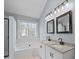 Bathroom with double vanity, granite countertops, tile floors, and a garden tub at 8733 Canter Post Dr, Charlotte, NC 28216