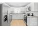 Bright kitchen features white cabinetry, granite countertops, stainless steel appliances, and modern fixtures at 8733 Canter Post Dr, Charlotte, NC 28216