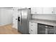 This kitchen features stainless steel appliances, white cabinetry, granite countertops, and modern fixtures at 8733 Canter Post Dr, Charlotte, NC 28216
