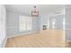 Bright and airy living area with hardwood floors, modern lighting, and a fireplace at 8733 Canter Post Dr, Charlotte, NC 28216