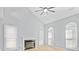 Bright living room with a fireplace, vaulted ceiling, hardwood floors, and large windows at 8733 Canter Post Dr, Charlotte, NC 28216
