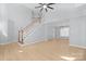 Spacious living room with hardwood floors, staircase, and ample natural light at 8733 Canter Post Dr, Charlotte, NC 28216