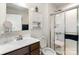 Bright bathroom featuring a vanity, enclosed shower, and convenient storage at 9740 Wardley Dr, Charlotte, NC 28215