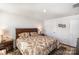 Sunlit bedroom featuring a decorative rug, floral-patterned bed set, and minimalist decor at 9740 Wardley Dr, Charlotte, NC 28215