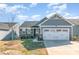 Charming single-Gathering home with stone accents, gray siding and a spacious two-car garage at 9740 Wardley Dr, Charlotte, NC 28215
