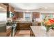 Granite countertops and stainless-steel appliances complement the warm wood cabinets in this cozy kitchen at 9740 Wardley Dr, Charlotte, NC 28215