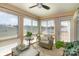 Inviting sunroom with ample windows, cozy seating, and natural light at 9740 Wardley Dr, Charlotte, NC 28215