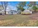 View of backyard with a shed with deck and the back of the house with driveway and carport at 1008 Bose Ave, Rock Hill, SC 29732