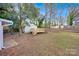 Backyard view of a shed with deck, trees, and grass in a partially cleared yard at 1008 Bose Ave, Rock Hill, SC 29732