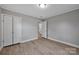 Bedroom featuring neutral walls, a closet and doorway leading to bathroom, with wood-look vinyl flooring at 1008 Bose Ave, Rock Hill, SC 29732