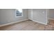 Bedroom featuring neutral walls, a window, closet, and wood-look vinyl flooring at 1008 Bose Ave, Rock Hill, SC 29732