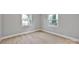 A bedroom featuring modern floors, neutral walls, and two large windows at 1008 Bose Ave, Rock Hill, SC 29732