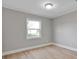 A bright bedroom featuring modern floors, neutral walls, and a large window at 1008 Bose Ave, Rock Hill, SC 29732