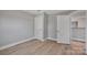 A bright bedroom featuring modern floors, neutral walls, and closet space at 1008 Bose Ave, Rock Hill, SC 29732