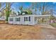 Charming single-story home featuring light gray siding, black shutters and a covered parking area at 1008 Bose Ave, Rock Hill, SC 29732