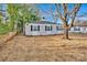 Charming single-story home featuring light gray siding, black shutters and manicured flower beds at 1008 Bose Ave, Rock Hill, SC 29732