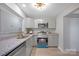 Updated kitchen features stainless steel appliances, granite countertops, and grey cabinetry at 1008 Bose Ave, Rock Hill, SC 29732
