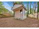 Shed in backyard with siding and a window on a lot covered with fallen pine needles at 1008 Bose Ave, Rock Hill, SC 29732