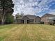 Expansive backyard featuring a well-manicured lawn and an attractive home exterior at 10521 Ardley Manor Dr, Mint Hill, NC 28227