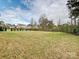 Large backyard enclosed with a black fence, offering ample space for recreation and outdoor activities at 10521 Ardley Manor Dr, Mint Hill, NC 28227