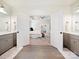 View of a main bedroom through the bathroom doorway with double vanity at 10521 Ardley Manor Dr, Mint Hill, NC 28227