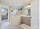 Bright bathroom features double vanity and walk-in shower with glass surround at 10521 Ardley Manor Dr, Mint Hill, NC 28227