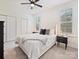Bright bedroom featuring a ceiling fan, neutral carpet, and two windows for lots of natural light at 10521 Ardley Manor Dr, Mint Hill, NC 28227