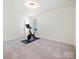 Neutral bedroom with a stationary bicycle and neutral carpet at 10521 Ardley Manor Dr, Mint Hill, NC 28227