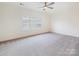 Neutral bedroom featuring a ceiling fan, and lots of natural light from the window at 10521 Ardley Manor Dr, Mint Hill, NC 28227
