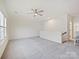 Spacious bonus room with neutral carpet, a ceiling fan, and lots of natural light at 10521 Ardley Manor Dr, Mint Hill, NC 28227