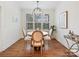 Cozy dining area with modern chandelier, plantation shutters, and wood floors at 10521 Ardley Manor Dr, Mint Hill, NC 28227