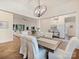 Open concept dining room and living room with hardwood floors and modern light fixtures at 10521 Ardley Manor Dr, Mint Hill, NC 28227