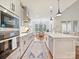 Elegant kitchen showcasing stainless steel appliances and a large island with a breakfast bar at 10521 Ardley Manor Dr, Mint Hill, NC 28227