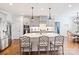 Bright kitchen features large center island, stainless steel appliances, and hardwood flooring at 10521 Ardley Manor Dr, Mint Hill, NC 28227