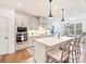 Stylish kitchen with stainless appliances, an island with seating and modern pendant lighting at 10521 Ardley Manor Dr, Mint Hill, NC 28227