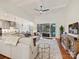 Bright open-concept living room with coffered ceilings, fan, hardwood floors and sliding glass doors to the backyard at 10521 Ardley Manor Dr, Mint Hill, NC 28227