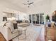 Bright open-concept living room with coffered ceilings, fan, hardwood floors and sliding glass doors to the backyard at 10521 Ardley Manor Dr, Mint Hill, NC 28227