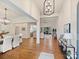 Spacious open-concept living room showcasing hardwood floors, high ceilings, and an abundance of natural light at 10521 Ardley Manor Dr, Mint Hill, NC 28227
