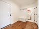 Mudroom featuring access to the laundry room and hardwood floors at 10521 Ardley Manor Dr, Mint Hill, NC 28227