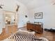 Hardwood floors, vaulted ceilings, large wooden desk, and Zebra rug in this well-appointed office at 10521 Ardley Manor Dr, Mint Hill, NC 28227