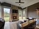 Screened in patio with a stone fireplace, tv, and outdoor furniture at 10521 Ardley Manor Dr, Mint Hill, NC 28227