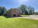 Brick home with an attached garage and large driveway offers convenience and ample parking at 108 W Jefferson St, York, SC 29745