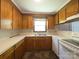 Functional kitchen featuring wooden cabinets and white appliances with tile floors at 108 W Jefferson St, York, SC 29745