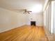 Spacious living room featuring a brick fireplace and hardwood flooring at 108 W Jefferson St, York, SC 29745
