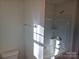 Bathroom features a shower-tub combo and neutral finishes at 112 Brook Creek Dr, Troutman, NC 28166