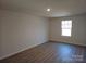 A bright bedroom features sleek wood floors and a window offering natural light at 112 Brook Creek Dr, Troutman, NC 28166