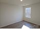 A bright bedroom boasts sleek wood floors and a window for plenty of natural light at 112 Brook Creek Dr, Troutman, NC 28166