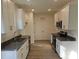 Galley kitchen featuring white cabinets, stainless steel appliances, granite countertops, and vinyl flooring at 112 Brook Creek Dr, Troutman, NC 28166