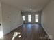A well-lit living room with wood floors, showcasing the open floor plan and lots of natural light at 112 Brook Creek Dr, Troutman, NC 28166