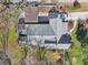 Aerial shot of a home with a grey roof, detached carport, and gravel driveway at 12 Church St, York, SC 29745